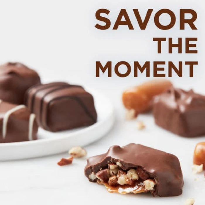 Chocolate-covered treats with nuts on a white surface, accompanied by the text 'SAVOR THE MOMENT'.