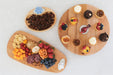 Three wooden platters with various food items on a white background
