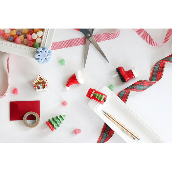 Crafting materials including scissors, ribbons, and decorative items on a white surface.
