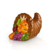 Cornucopia figurine filled with fruits and vegetables on a white background