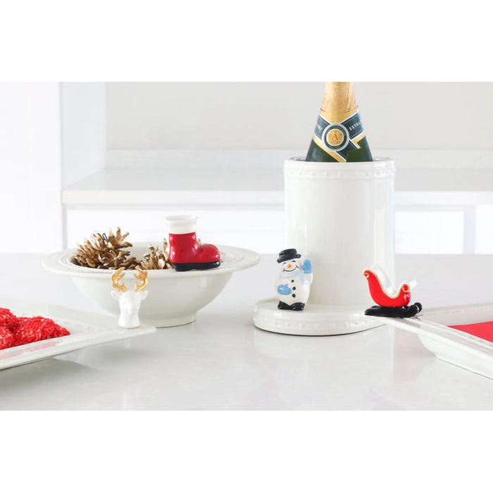 Decorative items including a snowman figurine, red boots, and a reindeer on a white surface.