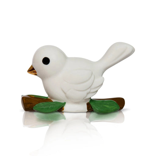 White ceramic bird figurine with green leaves on a white background