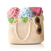 Decorative ceramic mini handbag with floral design on a white background
