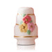 Decorative ceramic cake  Nora Fleming mini with floral designs on a white background