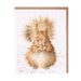 A greeting card featuring a cute squirrel sitting on a branch, surrounded by colorful autumn leaves.