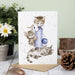 A card depicting two kittens engaged in playful antics with a ball.