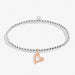 Silver bracelet with a rose gold heart charm on a white background