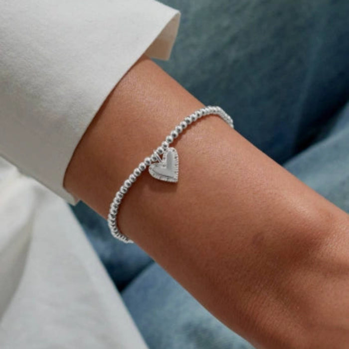 This A Littles & Co A Little 'Here's To Your Next Chapter' Bracelet celebrates exciting new beginnings. 