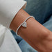 This A Littles & Co A Little 'Here's To Your Next Chapter' Bracelet celebrates exciting new beginnings. 
