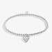 A delicate silver bracelet adorned with a charming heart pendant, perfect for any occasion.