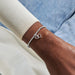 A stylish silver bracelet embellished with a heart charm, offering a timeless accessory for everyday wear.