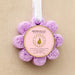 Purple bath sponge buffer with 'Spongellé' branding on a white background