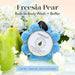 Blue bath buffer with a pear and flowers in the background, labeled 'Freesia Pear'.