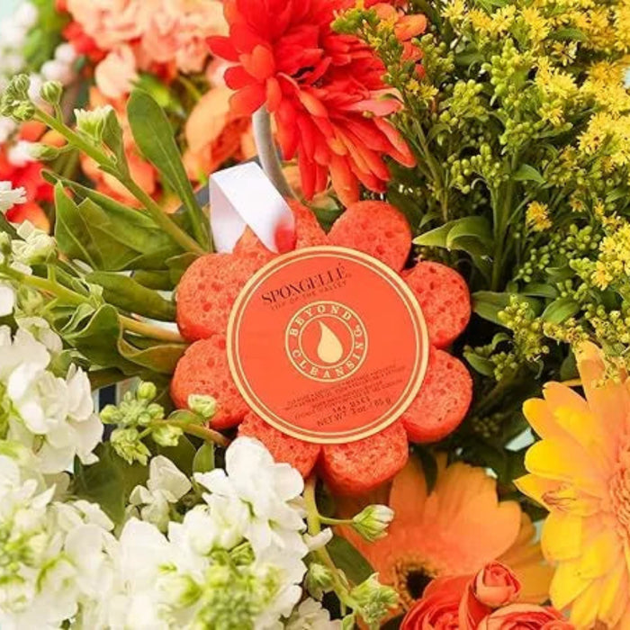Bouquet of colorful flowers with a decorative soap bar in the center on a light blue background