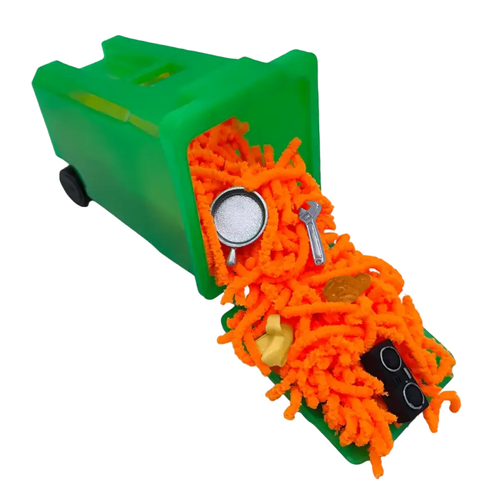 Green toy trash bin with orange shredded paper and small items on a white background