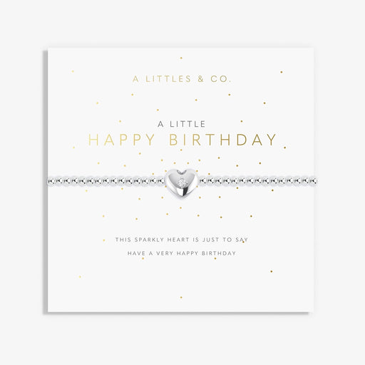 A Littles & Co A Little Happy Birthday bracelet with silver beaded stretch band and heart charm displayed on birthday sentiment card