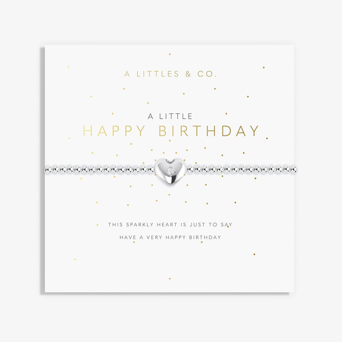A Littles & Co A Little Happy Birthday bracelet with silver beaded stretch band and heart charm displayed on birthday sentiment card