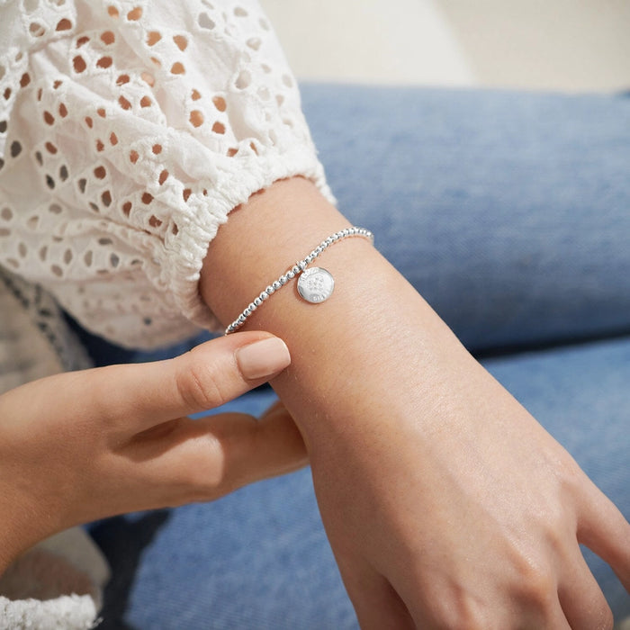 Close-up of a person wearing A Littles & Co. A Little 'Just For You Sister' Bracelet.