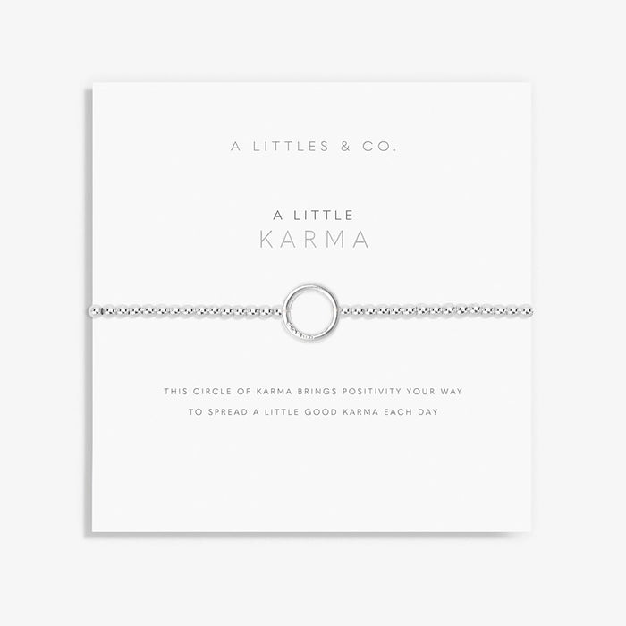 A Littles & Co. A Little Karma bracelet with silver beaded stretch band and circular charm on sentiment card