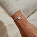 A Littles & Co. A Little Sending Love silver heart envelope charm bracelet worn on wrist