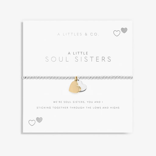 A Littles & Co. Soul Sisters bracelet worn on wrist featuring silver beaded band with gold and silver heart charms