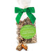 Bag of Abdallah Candies Dark Chocolate Almond Butter Toffee tied with a green bow, with pieces of toffee displayed in front.