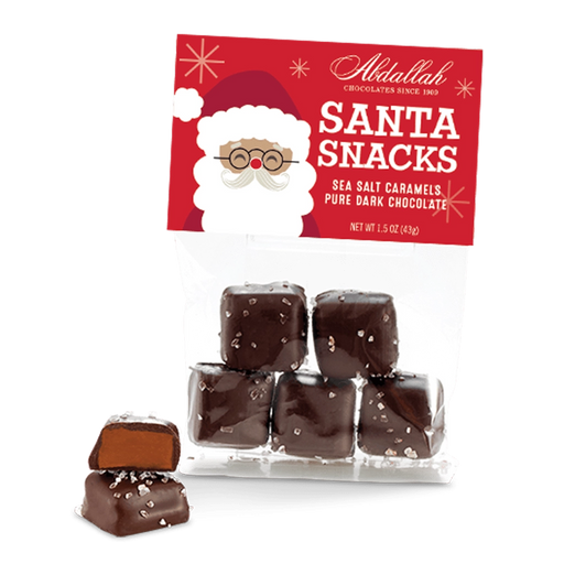 Bag of Abdallah Candies Santa Snacks milk chocolate caramels with festive Santa packaging and sea salt caramel pieces displayed in front.