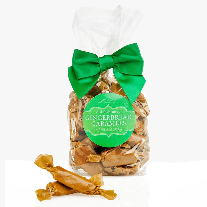 Bag of Abdallah Candies Twist Wrap Gingerbread Caramels with green bow and individually wrapped gingerbread-flavored caramels.