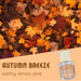 Autumn-themed product graphic for 'Autumn Breeze' reed diffuser. The top half shows a dense pile of colorful fall leaves in orange, yellow, brown, and red.