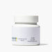 Pure face cream in a jar with a white lid, showcasing a smooth and creamy texture.