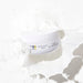 Pure face cream container with a white lid, highlighting its clean and minimalist design.