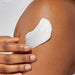 A smooth white cream spread evenly on a pristine white surface.