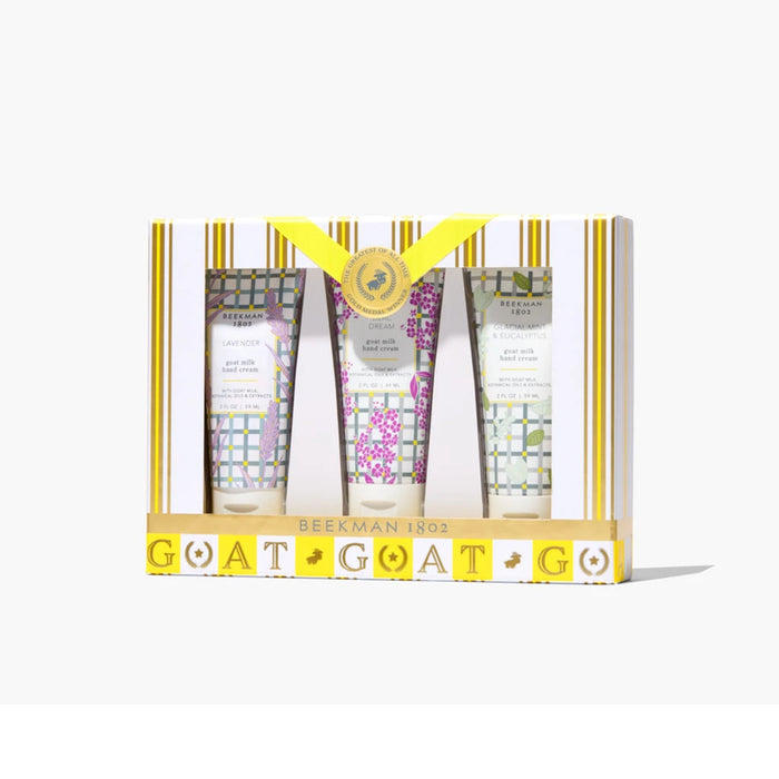 Three hand cream tubes adorned with floral designs, arranged together on a light background.