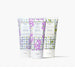 Three tubes of hand cream featuring colorful flower patterns, displayed side by side.
