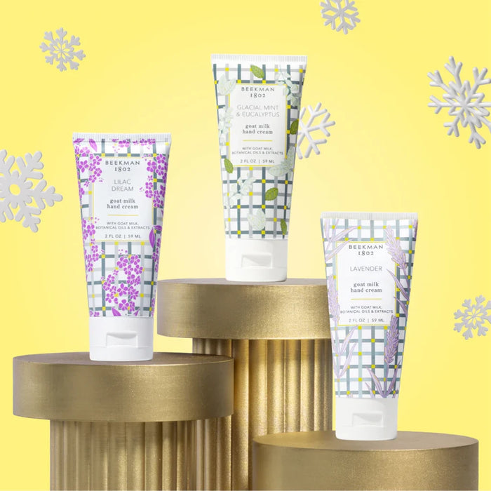 Three hand cream tubes with vibrant flower motifs, positioned closely together.