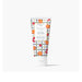 A tube of hand cream surrounded by fresh oranges and berries on a light background.