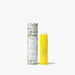 A tube of lip balm featuring a yellow and white patterned design.