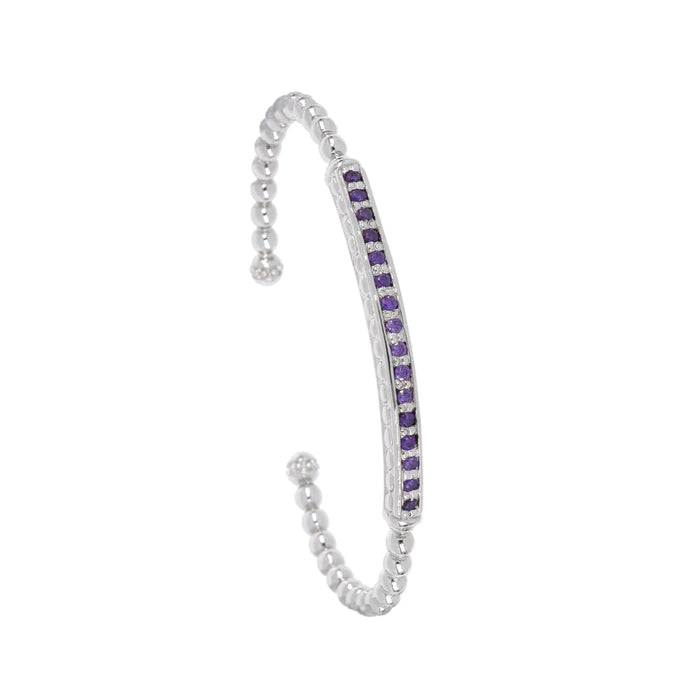 This rhodium-finished cuff features a striking pave bar detail that catches the light beautifully