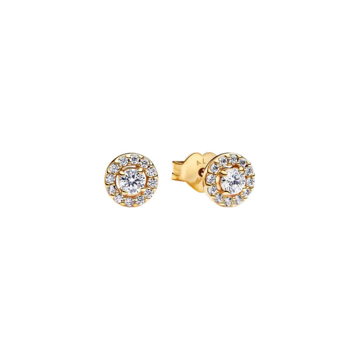 Gold earrings with clear gemstones on a white background