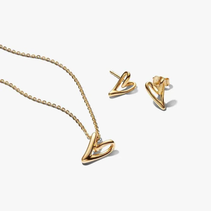 Gold necklace and earrings on a white background