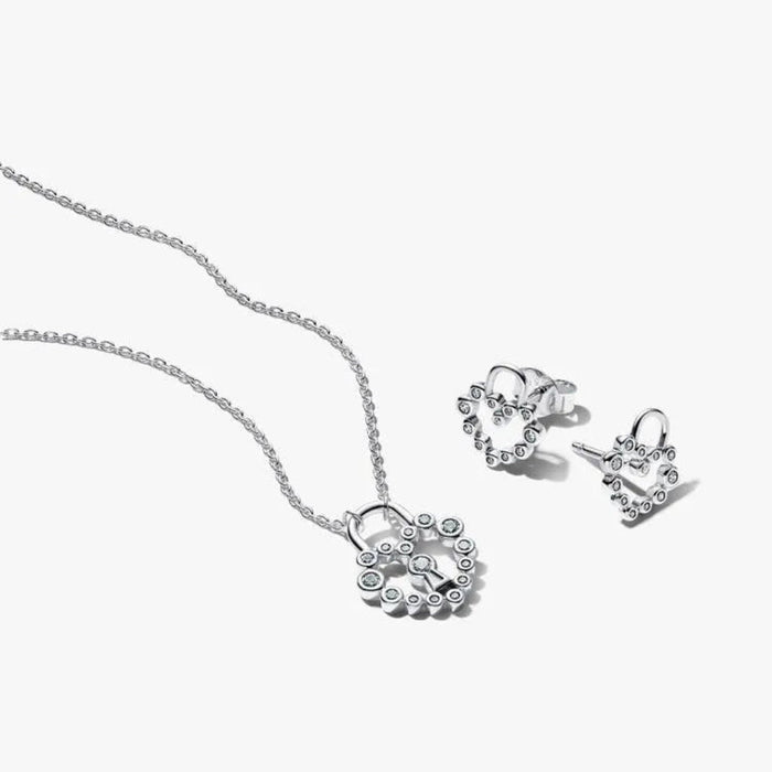 Silver necklace and earrings set on a white background