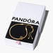 Gold bracelet in a Pandora box on a white background