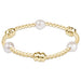 Admire Bracelet shown on a white background with gold beads and pearl detail