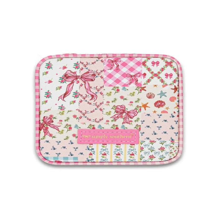 Simply Southern quilted jewelry case with pink trim and a patchwork print featuring bows, florals, gingham, and seashells.