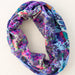 A vibrant boho bandana crafted from assorted colorful fabrics, displaying a unique blend of patterns and textures.
