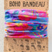 A vibrant scarf featuring a floral design in various colors.