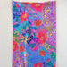 A colorful scarf adorned with a delicate flower pattern.