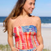 A vibrant boho bandeau crafted from colorful fabric, displaying an array of eye-catching designs.