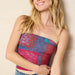 Eye-catching pink boho bandana with decorative motifs, great for enhancing personal style.