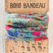 A colorful boho bandeau made of vibrant fabric, showcasing a blend of patterns and hues.